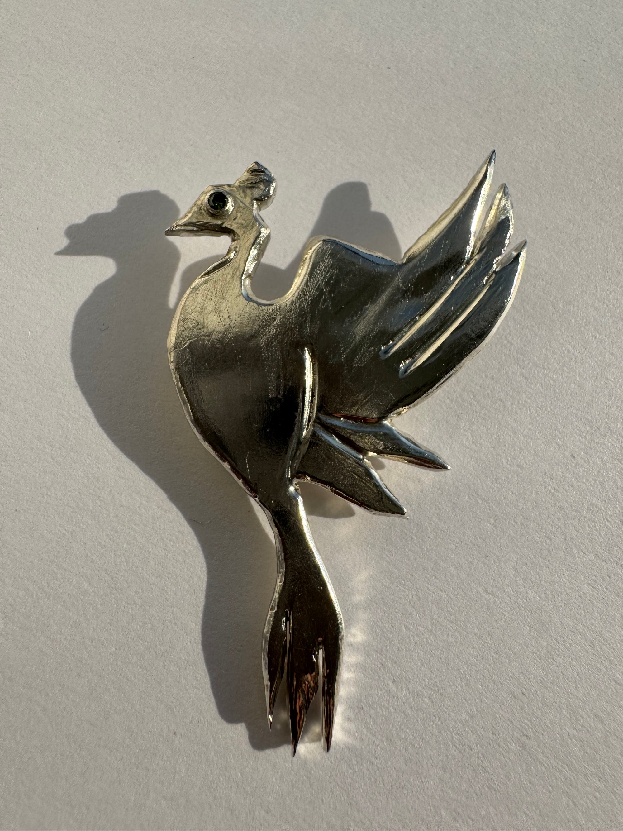 Phoenix Brooch handcrafted in recycled 935 Argentium silver with blue diamond eye made in New York City